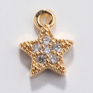 Macro shot of gold star charm with sparkling white zircons and sturdy loop for DIY jewelry