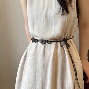 Bohemian dark brown braided waist belt with wooden buckle on beige pleated dress