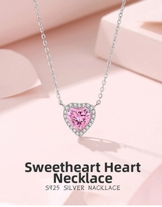 Macro detail of 925 silver heart necklace with pink zircon and micro-pave setting