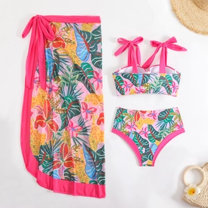 Detail view of a three-piece floral print swimwear set with matching long mesh sarong