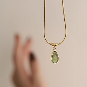 French style gold-plated snake chain necklace with a translucent green teardrop pendant