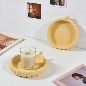 Close-up of yellow wavy edge decorative plaster tray with matte texture for home decor