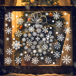 Close-up of white snowflake window clings with a festive hanging ornament design