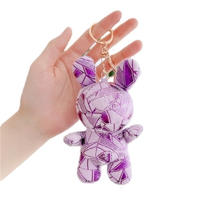 Cute purple plush bunny keychain with metallic geometric patterns and gold ring