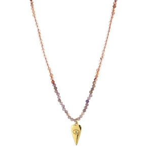 Macro detail of gold heart pendant with evil eye engraving on beaded tourmaline necklace