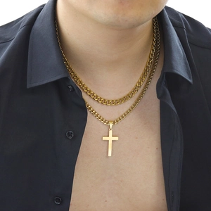 Close-up of golden double-layer cuban chain necklace with cross pendant on male model