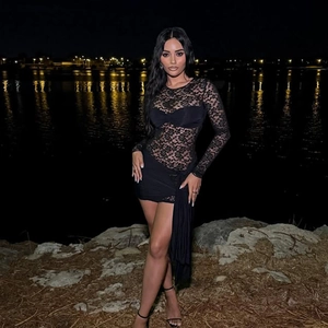 Elegant black lace long-sleeved bodycon dress with sheer hollow patterns and side ties
