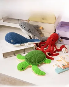 Detailed view of hand-crocheted shark, whale, octopus and turtle marine plush toys