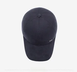 Overhead view of a dark winter baseball cap for men with premium twill texture and metal trim