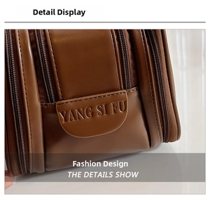 Detailed macro view of the premium brown leather toiletry bag with zipper compartments