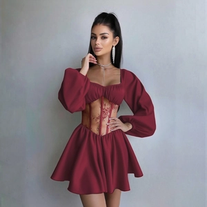 Détail de la robe rouge à épaules dénudées avec corset en dentelle et manches bouffantes