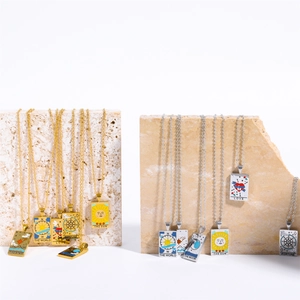 Detail of tarot card pendants including The Sun and Moon on marble stone display