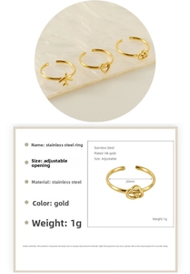 Detailed view of adjustable gold stainless steel rings with plane and heart motifs