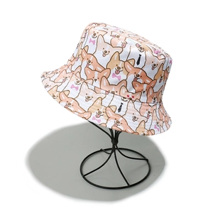 Detailed view of the cute cartoon corgi dog prints on white fabric bucket hat