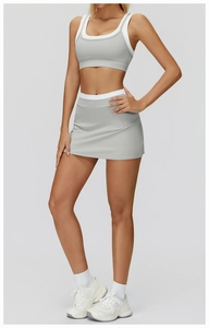 Detail of light grey yoga set with U-neck bra and high-waisted skirt for tennis