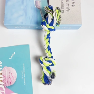 Three-color cotton rope dog toy with double knots on a minimalist white background