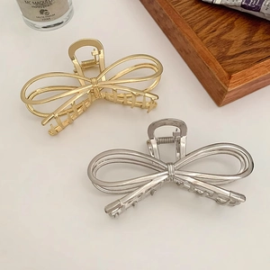Elegant large metal bow claw hair clips in gold and silver finish for women's hairstyles