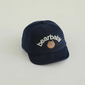 Détail de la broderie ours et du texte sur la casquette en coton bleu marine pour bébé