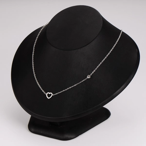Elegant silver stainless steel necklace featuring a hollow heart pendant on a black bust