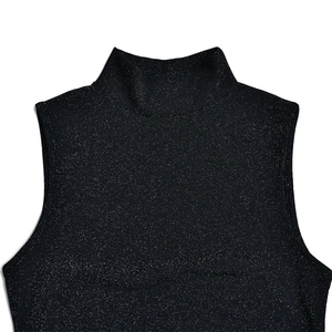 Close-up of black metallic glitter fabric on a chic sleeveless mock neck dress