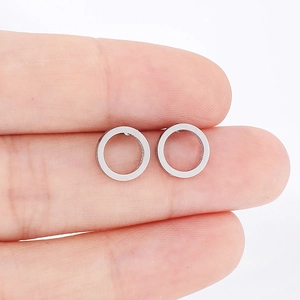 Detailed macro view showing the size and metallic luster of silver stainless steel hoop earrings