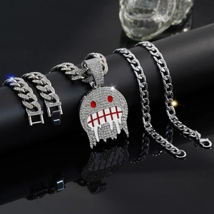 Macro detail of silver iced-out ghost pendant with red eyes on a Cuban link chain set