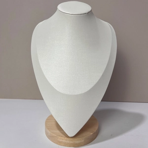 Detail of white necklace bust display with a natural beech wood round base for jewelry