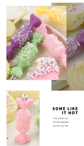 Close-up of candy-shaped Christmas ornaments with glitter finish in pastel colors
