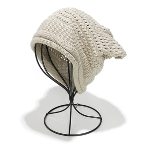 Cream white slouchy knit beanie with textured hollow patterns for winter warmth