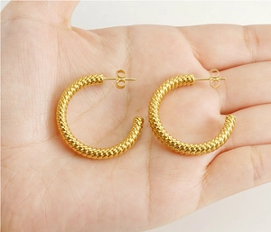 Detailed macro view of large 18k gold plated stainless steel twisted rope hoop earrings