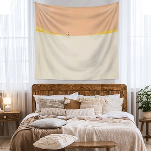 Cozy bedroom wall hanging featuring minimalist orange sunset illustration tapestry