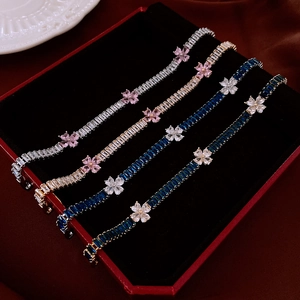 Detail of zircon flower bracelets with colorful square gemstones in a jewelry box