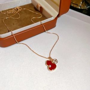 Detail of red gourd pendant necklace with sparkling zircon in rose gold finish