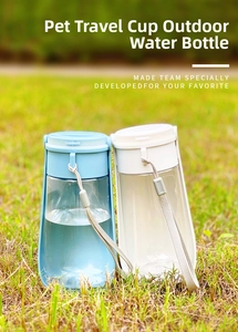Blue and white portable pet water dispensers with foldable trough on green grass