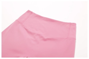 Close-up of pink high-waist yoga pants with reinforced stitching for tummy control
