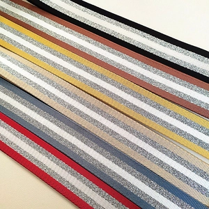 Detail of colorful striped woven bag straps with subtle metallic silver thread accents