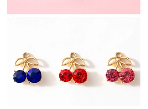 Detailed macro view of cherry pendants with sparkling rhinestones in three colors