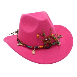 Detailed view of bohemian ethnic beads and shell decor on a magenta wool cowboy hat