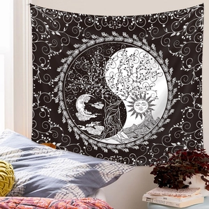 Detail of bohemian black and white tree of life tapestry hanging in a cozy bedroom