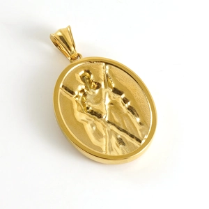Detailed macro view of an oval gold pendant featuring a religious saint relief design