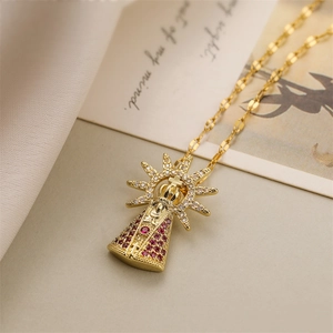 Macro shot of gold-plated crown pendant with white diamonds and red zircon stones