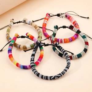 Detail of bohemian handmade woven friendship bracelets with adjustable black knots