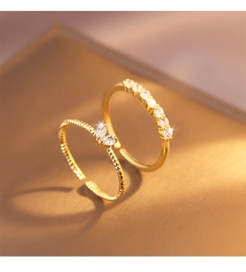 Macro detail of gold double-layer heart rings with butterfly zircon and pave crystals