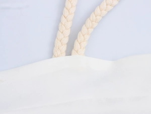 Detailed close-up of woven cotton rope strap and canvas texture on a printed maxi dress