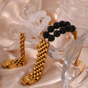 Close-up of luxury gold stainless steel watch-band bracelet with black and white stones