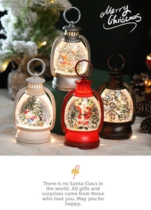 Detailed view of four colorful LED Christmas lanterns with miniature festive scenes