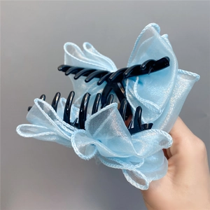 Elegant light blue organza bow hair claw clip with a black plastic base for women