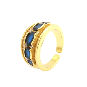 Detail of 18K gold X-shape ring featuring oval navy blue stones and micro-pave zircons