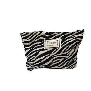 Large zebra print canvas makeup bag with Time to Party label and blue zipper