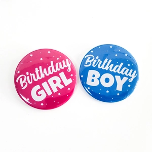 Detail of pink Birthday GIRL and blue Birthday BOY tinplate badges for party decoration